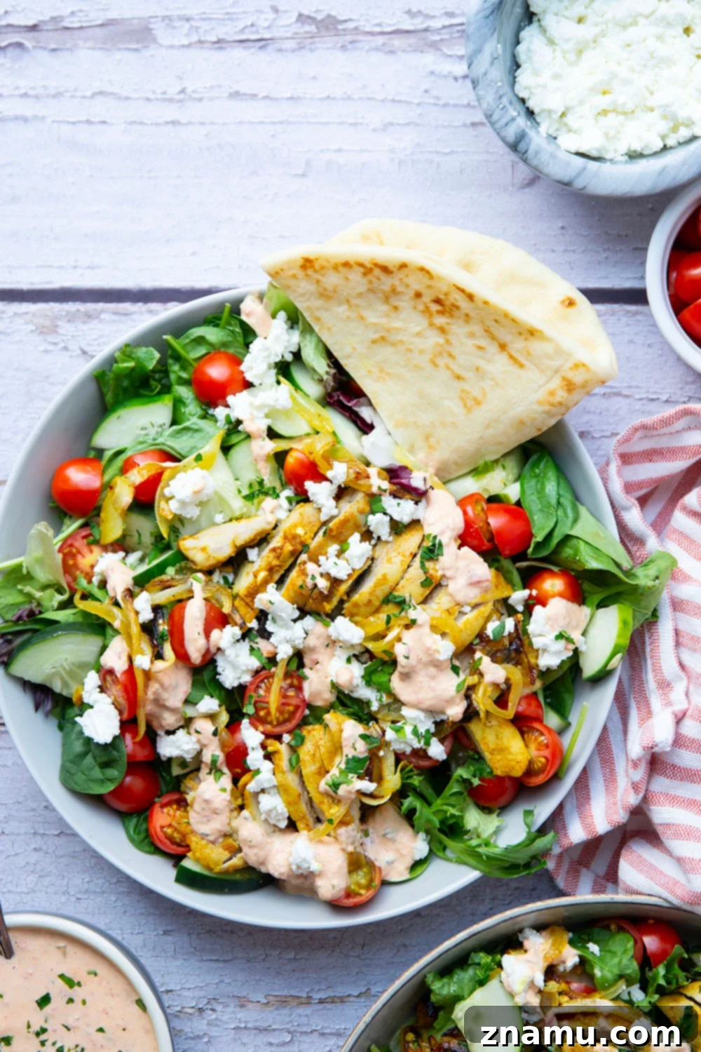 Mediterranean Chicken Shawarma Salad with Smoky Red Pepper Tzatziki 2 Everything you love about a good chicken shawarma is packed into this loaded salad! Juicy marinated chicken thighs and a flavorful roasted red pepper tzatziki take it over the top.