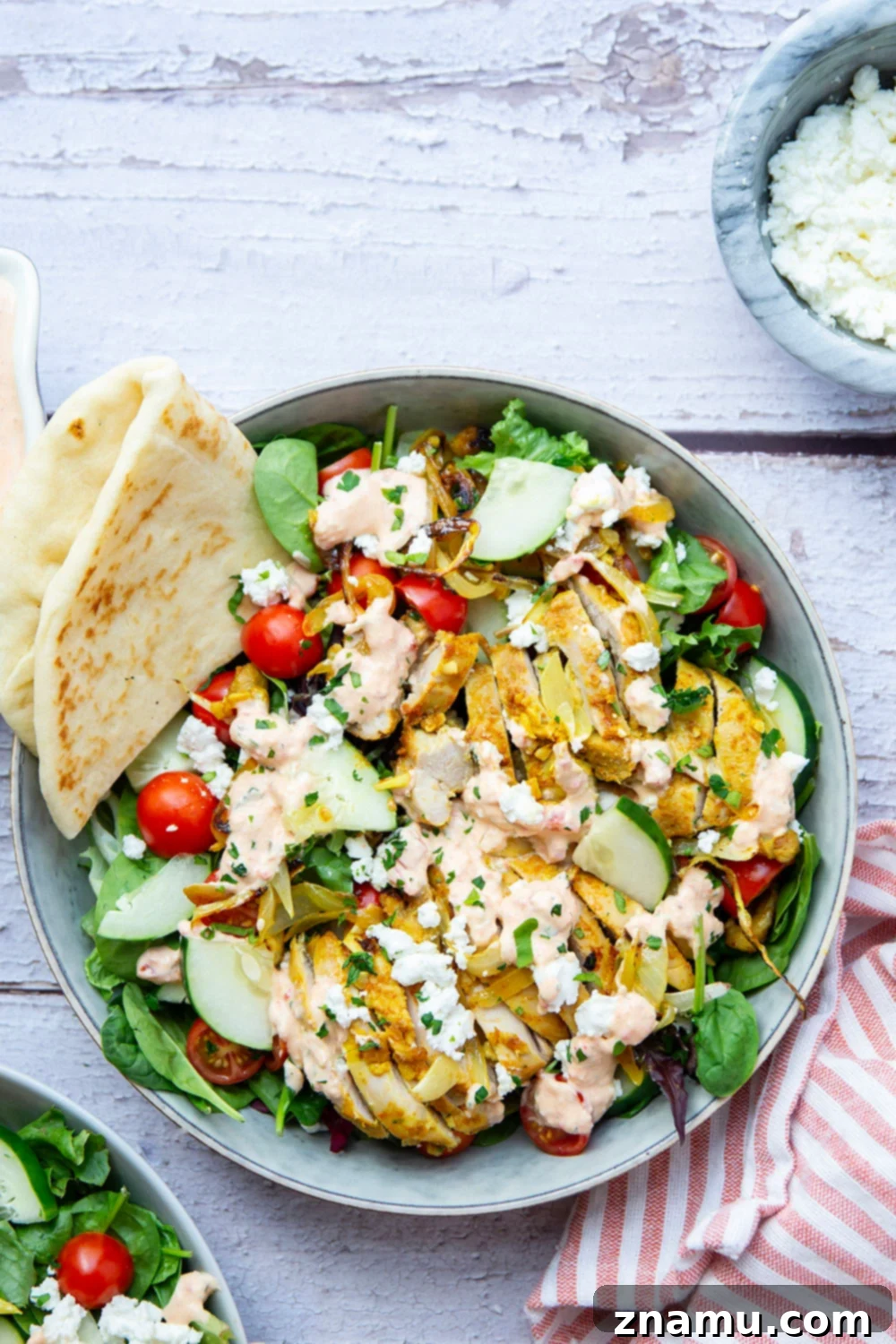 Mediterranean Chicken Shawarma Salad with Smoky Red Pepper Tzatziki 5 Everything you love about a good chicken shawarma is packed into this loaded salad! Juicy marinated chicken thighs and a flavorful roasted red pepper tzatziki take it over the top.