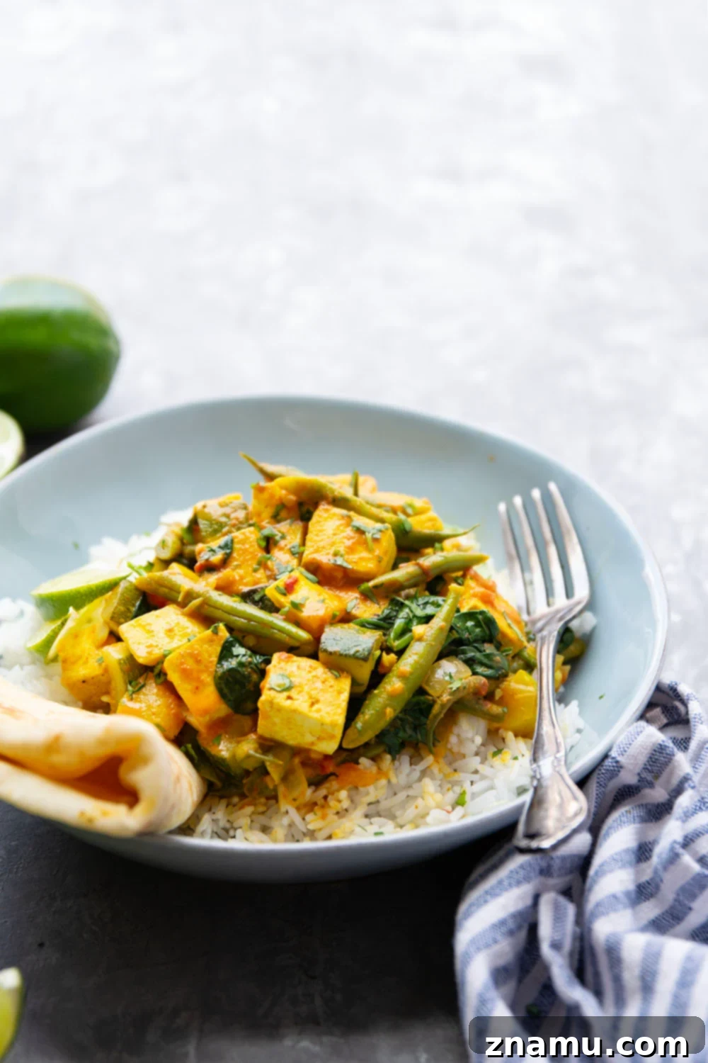 Fresh Summer Tofu Red Curry 6 A complete meal: Tofu Red Curry served with fluffy jasmine rice, fresh cilantro, lime wedges, and warm naan bread.
