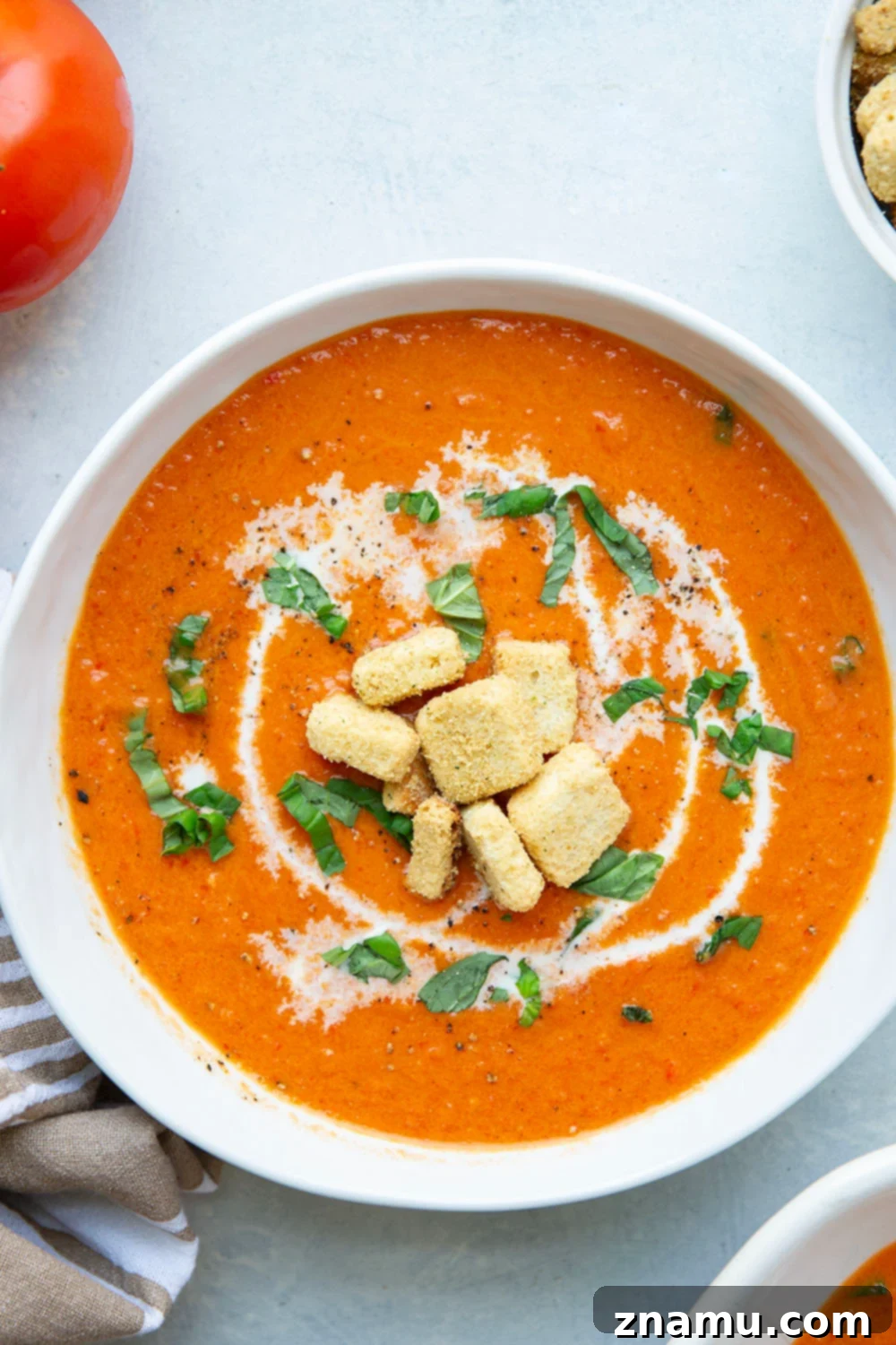 Crimson Fire-Roasted Tomato & Pepper Bisque 5 A close-up of the creamy roasted red pepper tomato soup in a bowl, ready to be served, emphasizing its inviting texture.