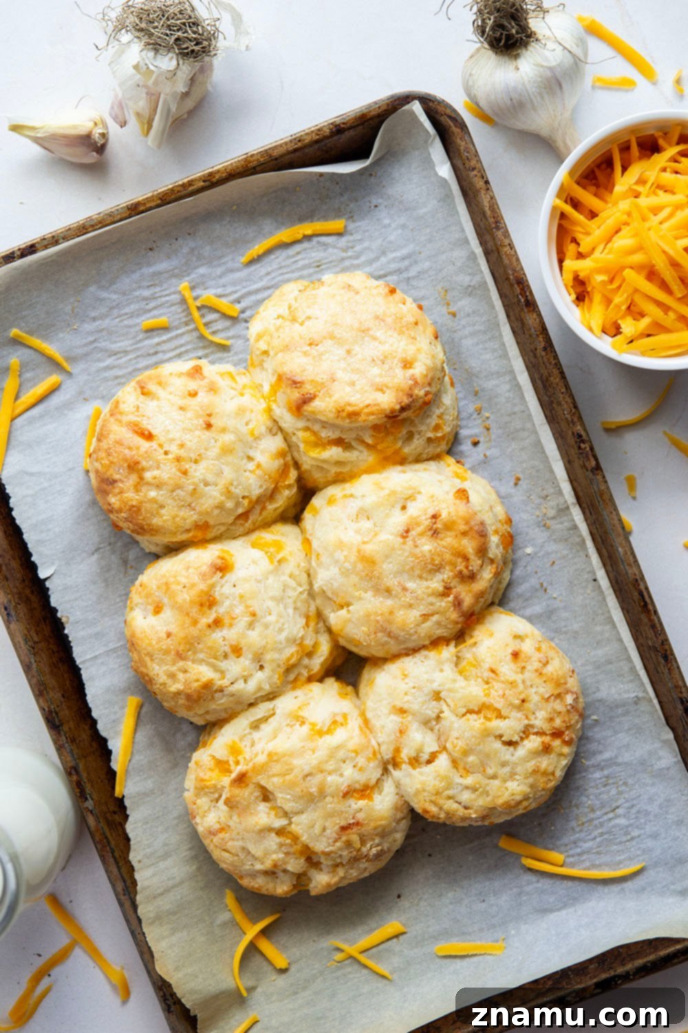 Artisan Roasted Garlic & Sharp Cheddar Biscuits 3 These roasted garlic cheddar biscuits boast a lovely roasted garlic flavor and plenty of gooey cheddar cheese. They are quick to make, light, and flaky!