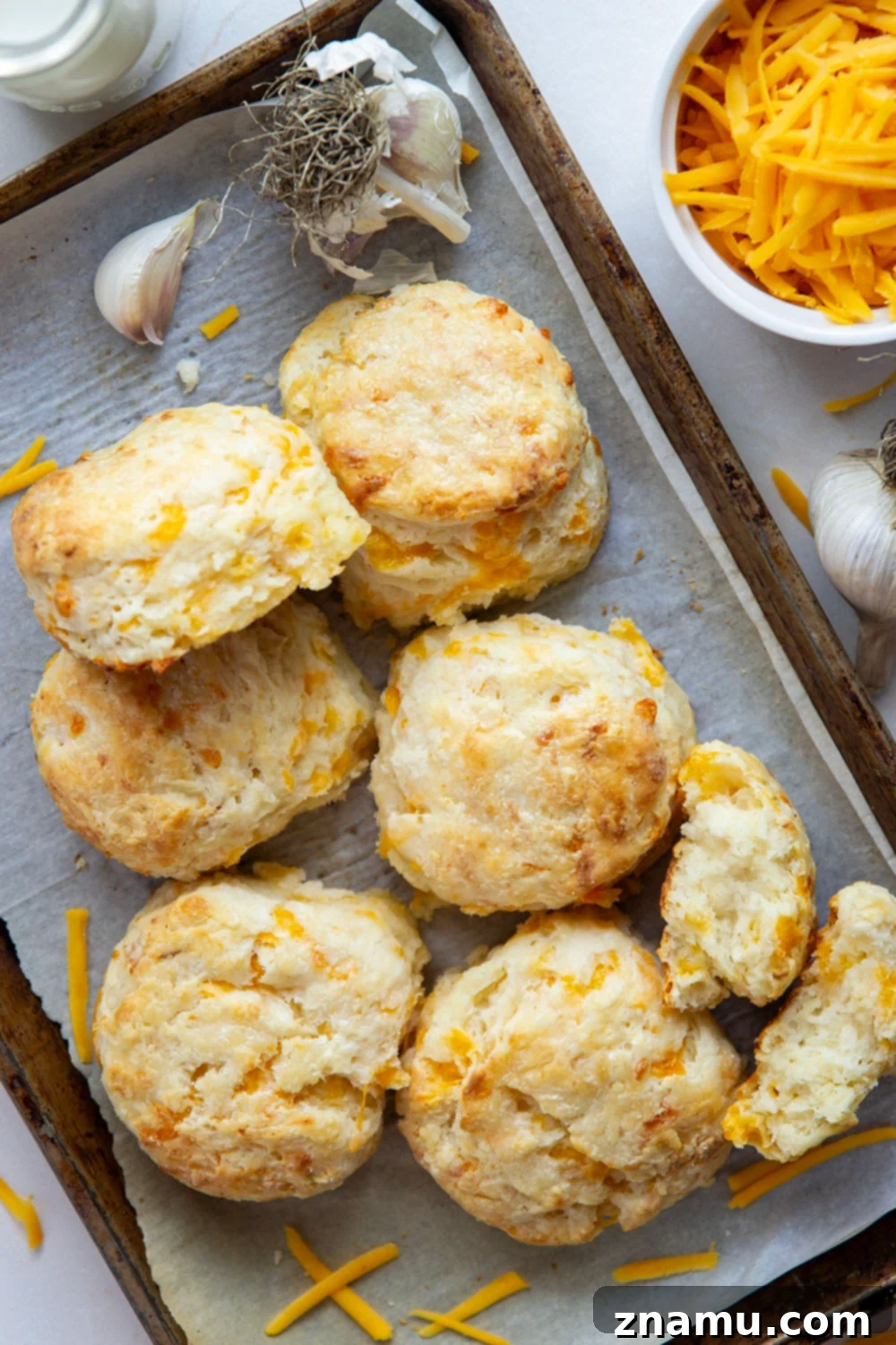 Artisan Roasted Garlic & Sharp Cheddar Biscuits 5 These roasted garlic cheddar biscuits boast a lovely roasted garlic flavor and plenty of gooey cheddar cheese. They are quick to make, light, and flaky!