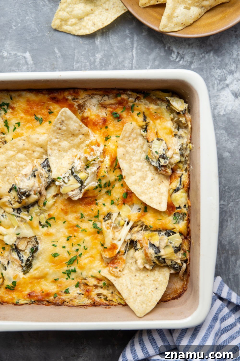 Sweet Caramelized Onion & Spinach Artichoke Bake 4 Ingredients laid out for making the baked spinach artichoke dip.