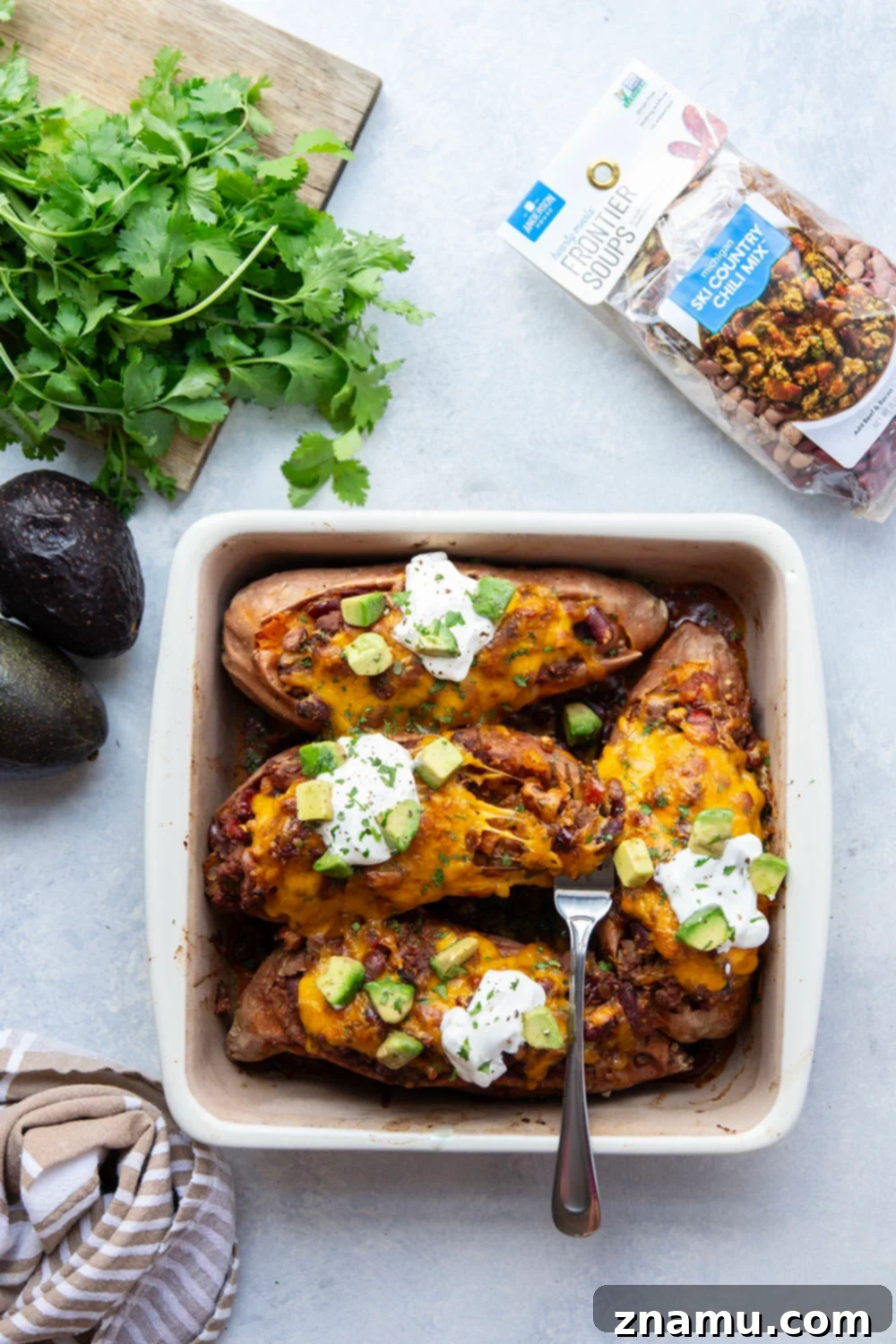 Ultimate Cheesy Chili Sweet Potatoes 2 Hearty chili-stuffed sweet potatoes, baked with gooey cheese, perfect for a fun chili night and loaded with toppings.
