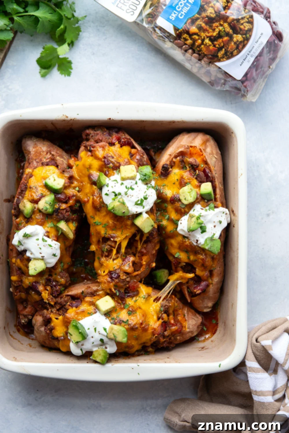 Ultimate Cheesy Chili Sweet Potatoes 4 Close-up of chili stuffed sweet potatoes, showcasing the vibrant colors of the chili and the melted cheese, ready for serving.