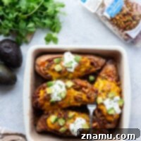 Stuffed with hearty chili and baked with lots of gooey cheese on top, these chili stuffed sweet potatoes are a fun way to do chili night and amazing loaded up toppings.