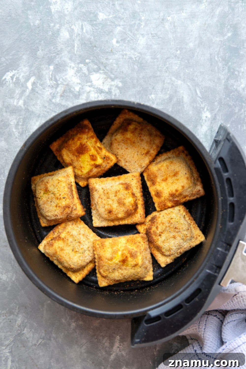 Crispy Air Fryer Ravioli 3 Close-up of perfectly golden and crispy Air Fryer Toasted Ravioli on a plate.