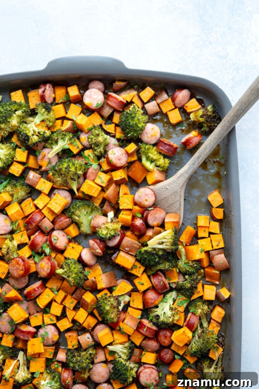 Sticky Honey Garlic Sheet Pan Sausage and Sweet Potatoes 5 Sliced chicken or turkey sausage links, ready for preparation in a honey garlic sheet pan recipe.