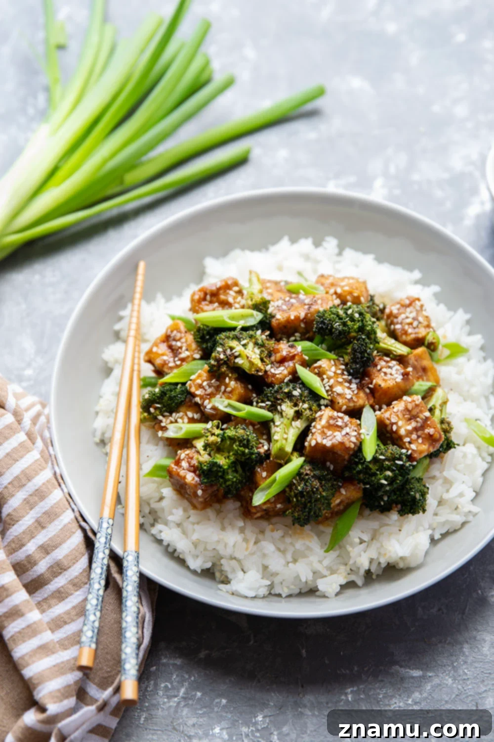 Perfectly Crispy Air Fryer Sesame Tofu and Broccoli 4 A bowl of Air Fryer Sesame Tofu and Broccoli served over white rice, ready to eat.