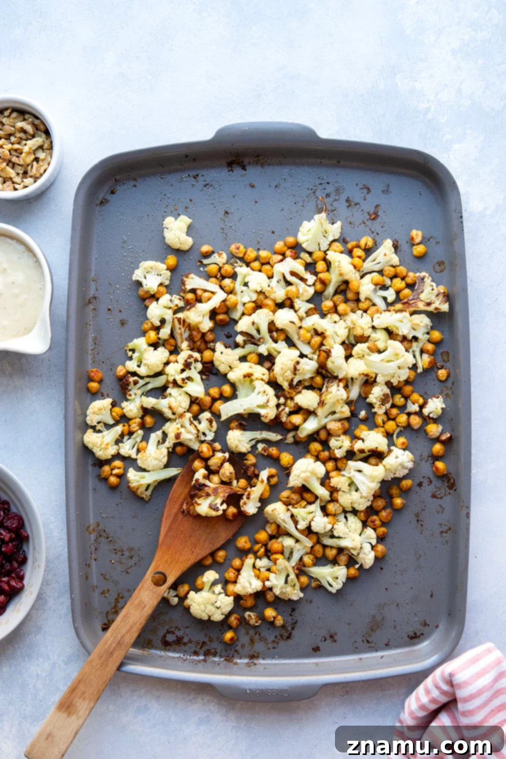 Warm Roasted Cauliflower & Chickpea Salad with Creamy Tahini Dressing 4 Crispy roasted cauliflower and chickpeas and a creamy roasted garlic tahini dressing are the perfect salad combination in this hearty roasted cauliflower chickpea salad.