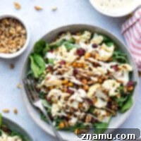 Warm Roasted Cauliflower & Chickpea Salad with Creamy Tahini Dressing 8 Crispy roasted cauliflower and chickpeas and a creamy roasted garlic tahini dressing are the perfect salad combination in this hearty roasted cauliflower chickpea salad.