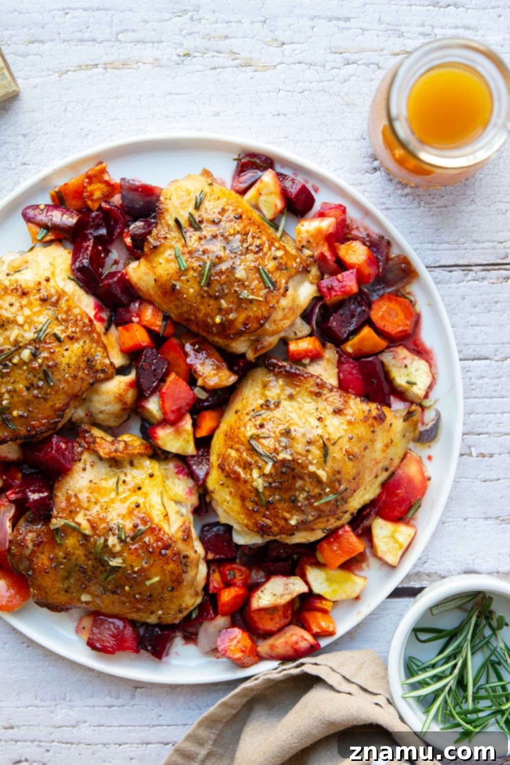 Apple Cider Chicken Thighs and Roasted Roots 2 Juicy apple cider glazed chicken thighs with roasted root vegetables, a perfect fall dinner.