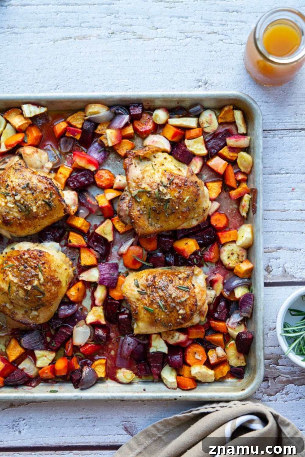 Apple Cider Chicken Thighs and Roasted Roots 5 Crispy chicken thighs and roasted vegetables glistening with apple cider glaze.