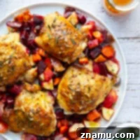 Juicy apple cider glazed chicken thighs with roasted root vegetables, a perfect fall dinner.