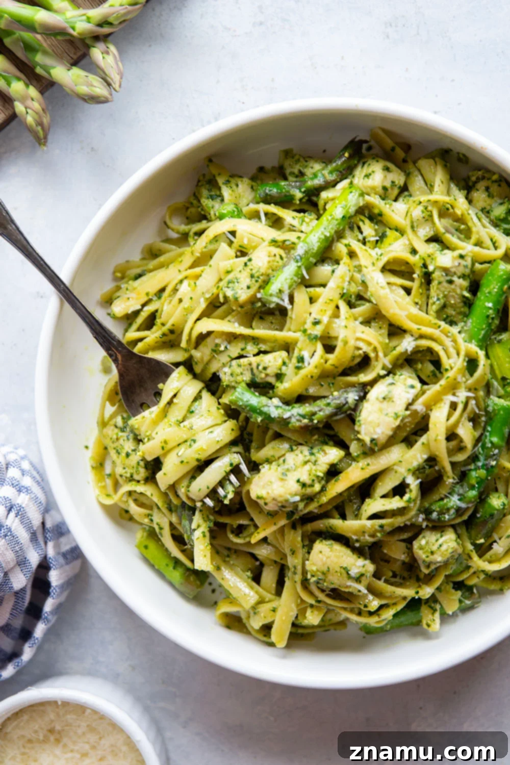 Vibrant Chicken Asparagus Pesto Pasta 5 This chicken asparagus pesto pasta features tender fettuccine pasta tossed with sautéed chicken, asparagus, and lots of flavorful pesto.