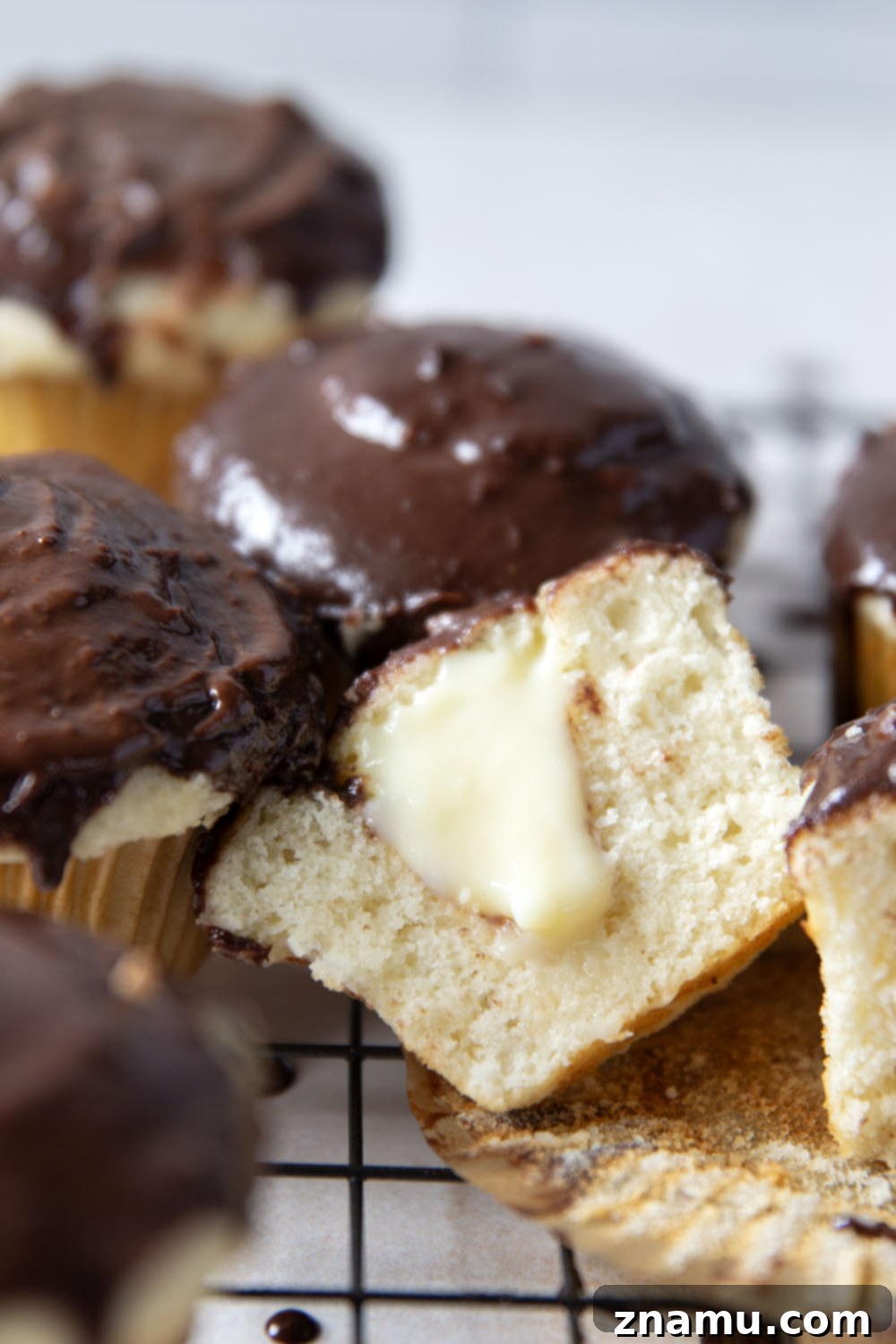 Classic Boston Cream Pie Cupcakes 5 These Boston cream pie cupcakes feature soft and buttery white cupcakes filled with vanilla pastry cream and topped with rich chocolate ganache.
