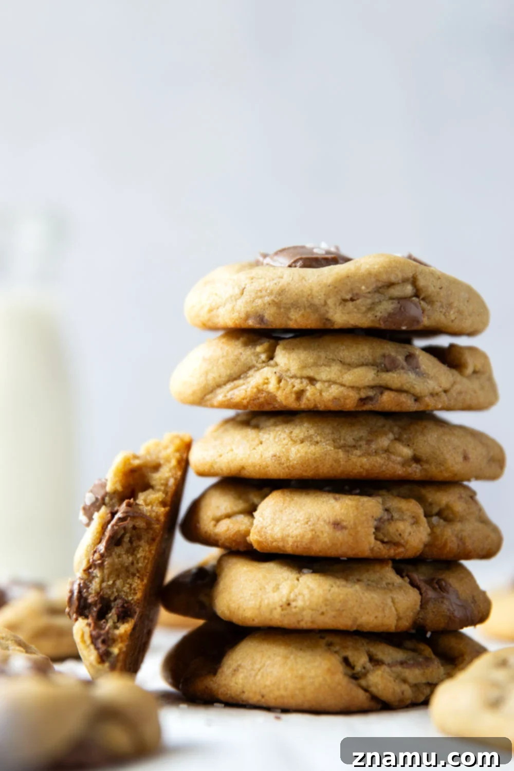 Decadent Brown Butter Chocolate Chunk Cookies 4 Three golden brown butter chocolate chunk cookies on a cooling rack, showcasing their inviting texture.