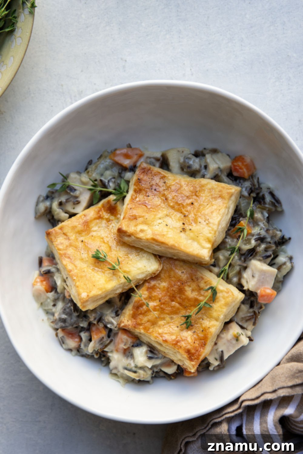 Hearty Turkey Wild Rice Pot Pie 3 This turkey wild rice pot pie features a creamy filling of wild rice and turkey with flaky homemade pastry squares baked on top. It's the perfect use for leftover turkey!