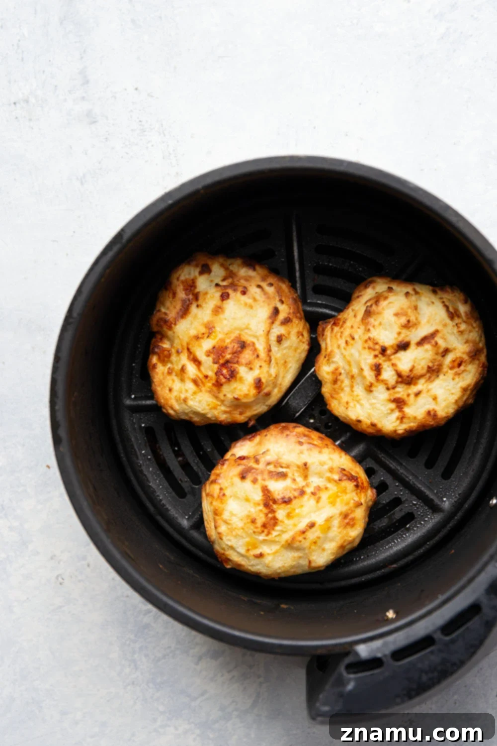 Crispy Air Fryer Mashed Potato Cakes 3 Air Fryer Mashed Potato Cakes with a golden-brown crust.