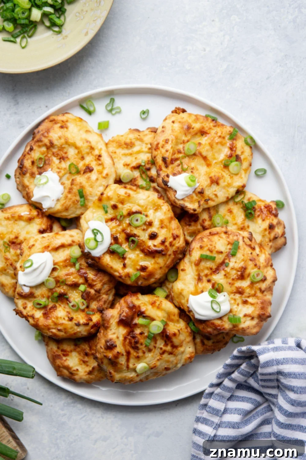 Crispy Air Fryer Mashed Potato Cakes 6 Air Fryer Mashed Potato Cakes served with sour cream and green onions.