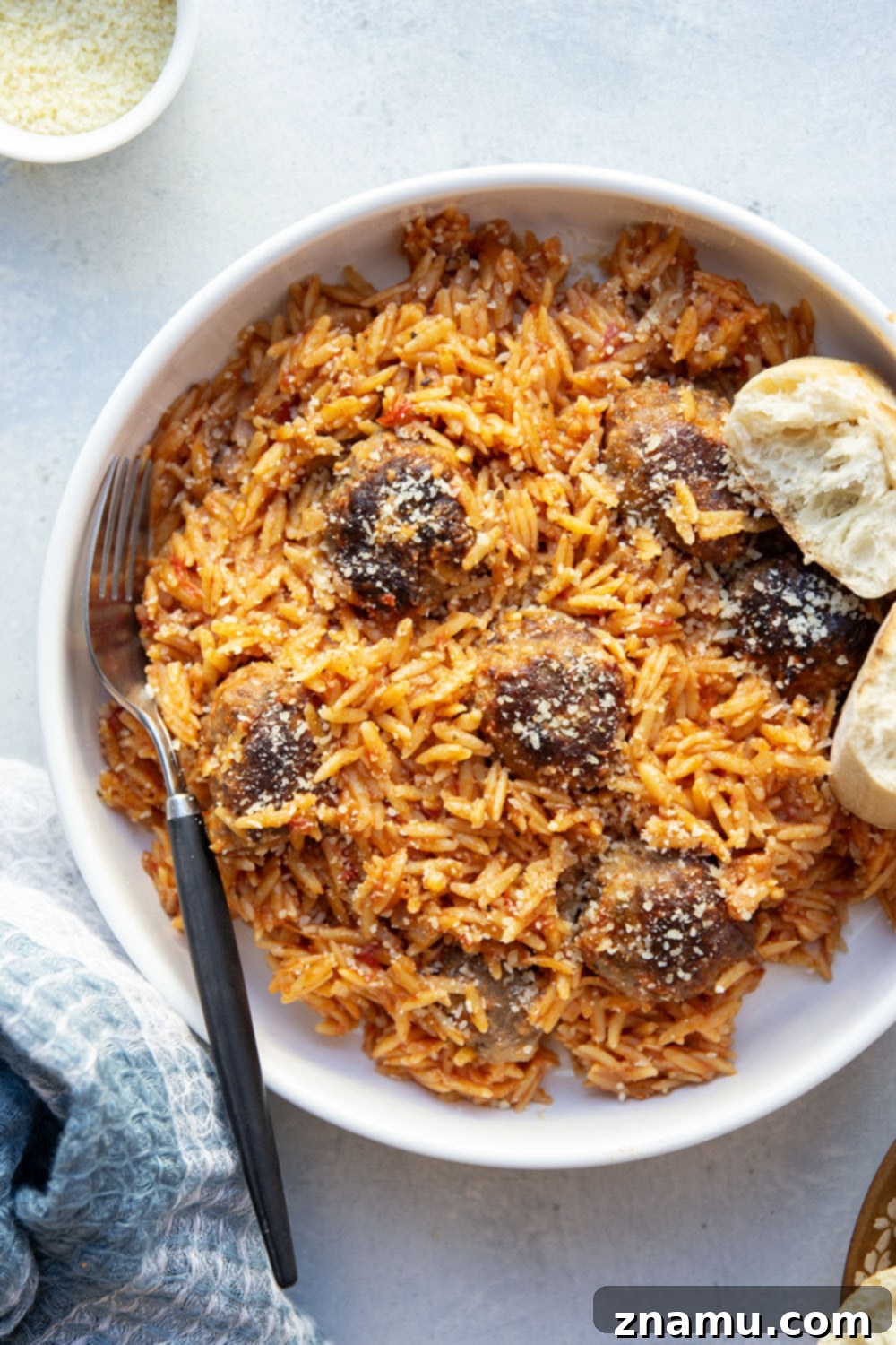 Creamy Vodka Orzo with Meatballs 4 A serving of meatballs and orzo in vodka sauce, garnished with fresh basil.