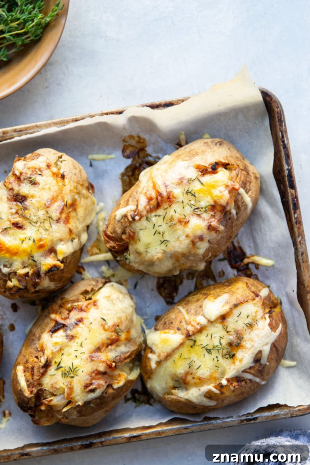 Bistro French Onion Baked Potatoes 2 Perfectly baked russet potatoes ready for filling with French onion soup.