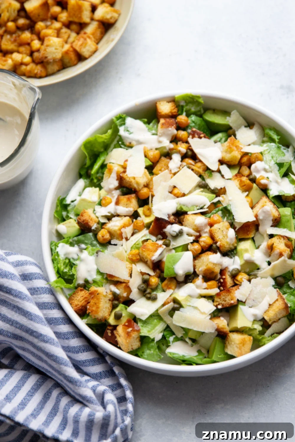 Crispy Chickpea & Creamy Avocado Caesar 3 Loaded with silky avocado, sharp Parmesan, and crispy chickpeas and croutons, this chickpea caesar salad is a delicious twist on the classic and goes well with so many meals!