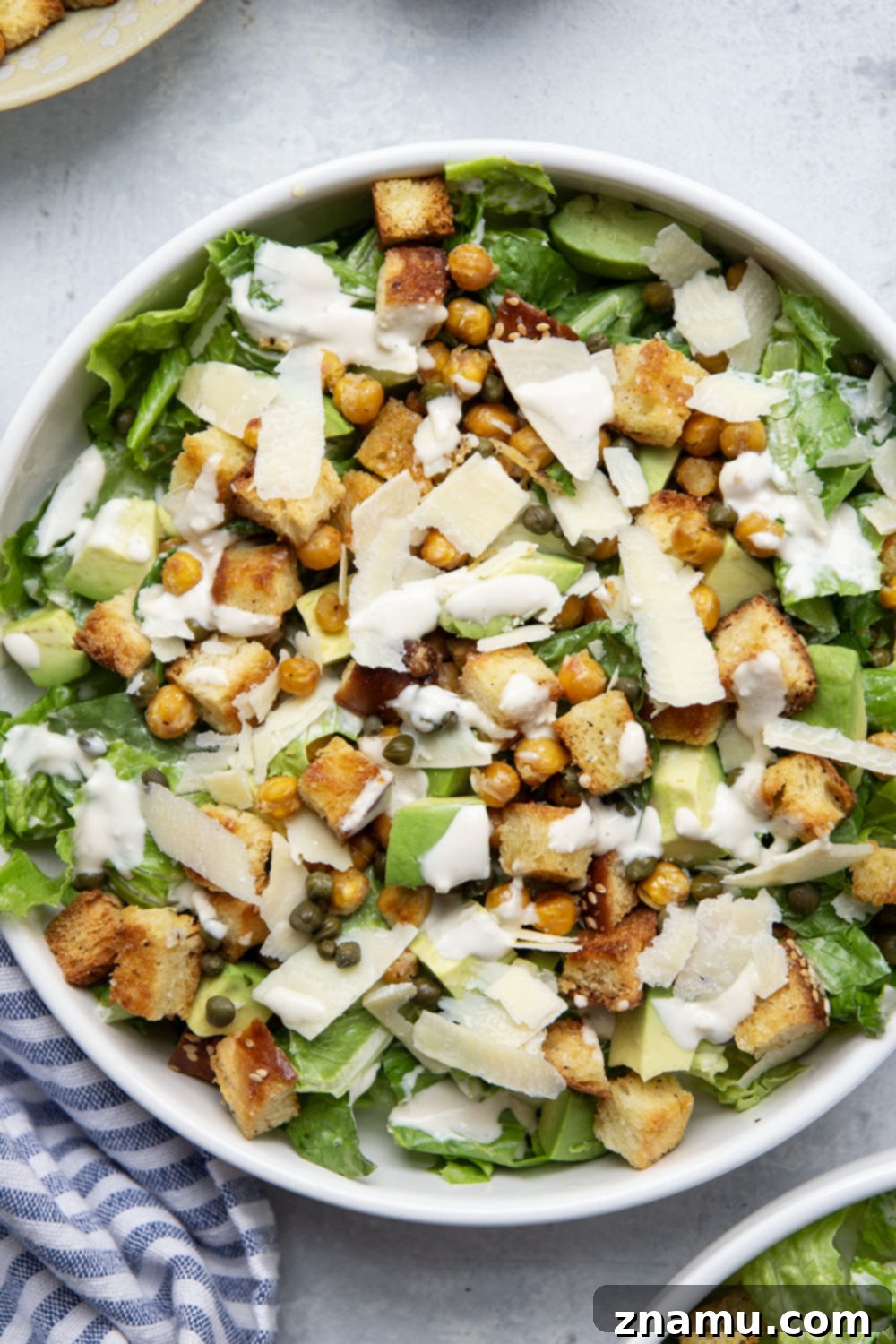 Crispy Chickpea & Creamy Avocado Caesar 4 Loaded with silky avocado, sharp Parmesan, and crispy chickpeas and croutons, this chickpea caesar salad is a delicious twist on the classic and goes well with so many meals!