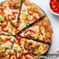Creamy homemade alfredo sauce, juicy chicken cubes, and flavorful roasted red peppers are the perfect trio in this alfredo roasted red pepper pizza! Top slices with lots of fresh basil for extra flavor.