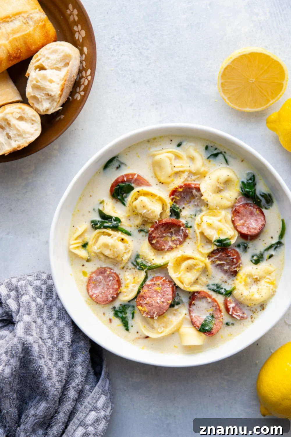 Sunshine Lemon Tortellini Soup 2 A beautifully presented bowl of creamy lemon tortellini soup, garnished with fresh herbs and lemon slices, ready to be enjoyed.