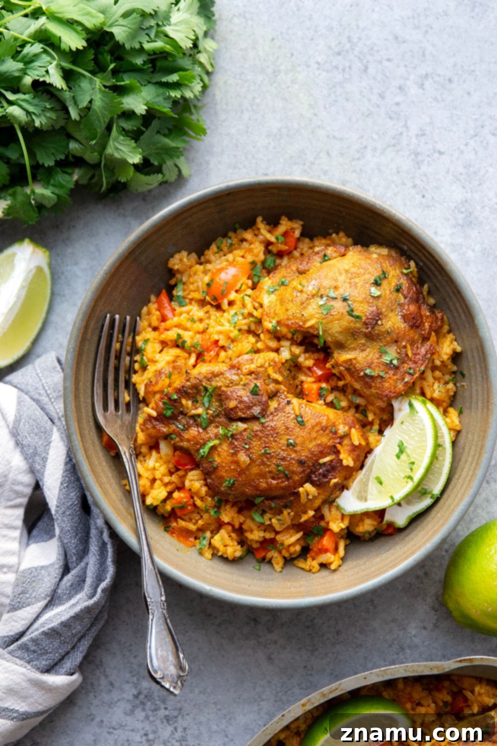 Effortless One-Pan Curry Chicken Dinner 3 Overhead view of a vibrant One Pot Curry Chicken and Rice dish, highlighting the golden-brown chicken, brightly colored vegetables, and fragrant rice, ready to be served from a single pot.