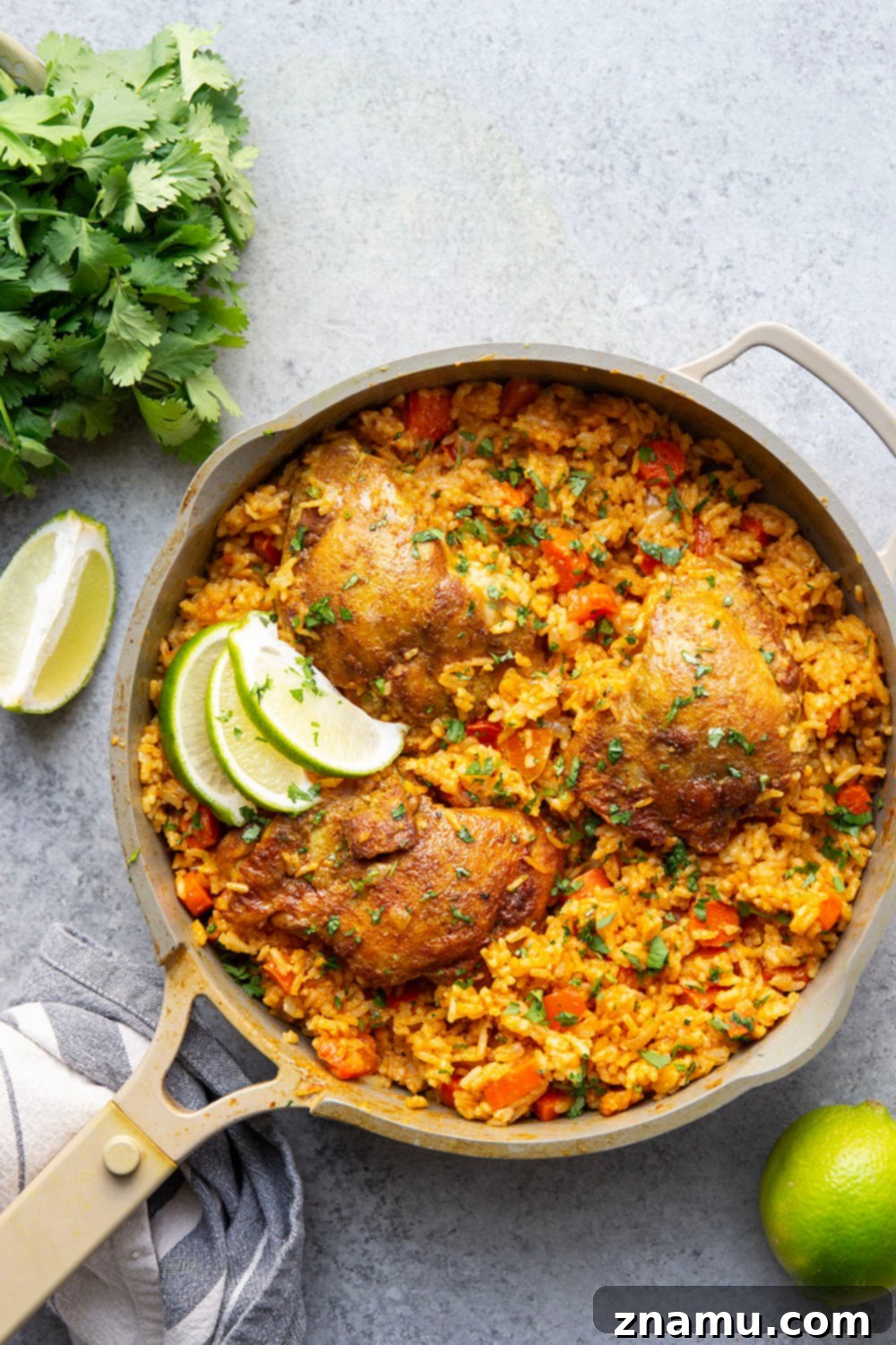 Effortless One-Pan Curry Chicken Dinner 4 A close-up of a spoon scooping a portion of One Pot Curry Chicken and Rice, showing the texture of the rice, chicken, and finely diced vegetables.