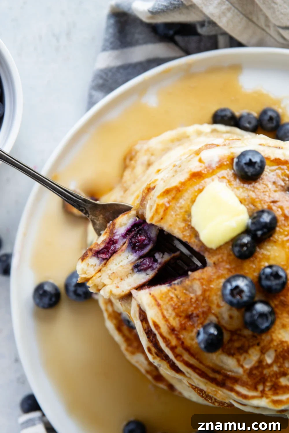 Pillowy Blueberry Ricotta Pancakes 5 A bowl of fresh blueberries next to a container of ricotta cheese