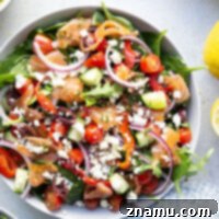 This smoked salmon Greek salad is a twist on the classic and features flavorful smoked salmon with a tangy lemon dill vinaigrette tossed with greens and lots of Greek ingredients.