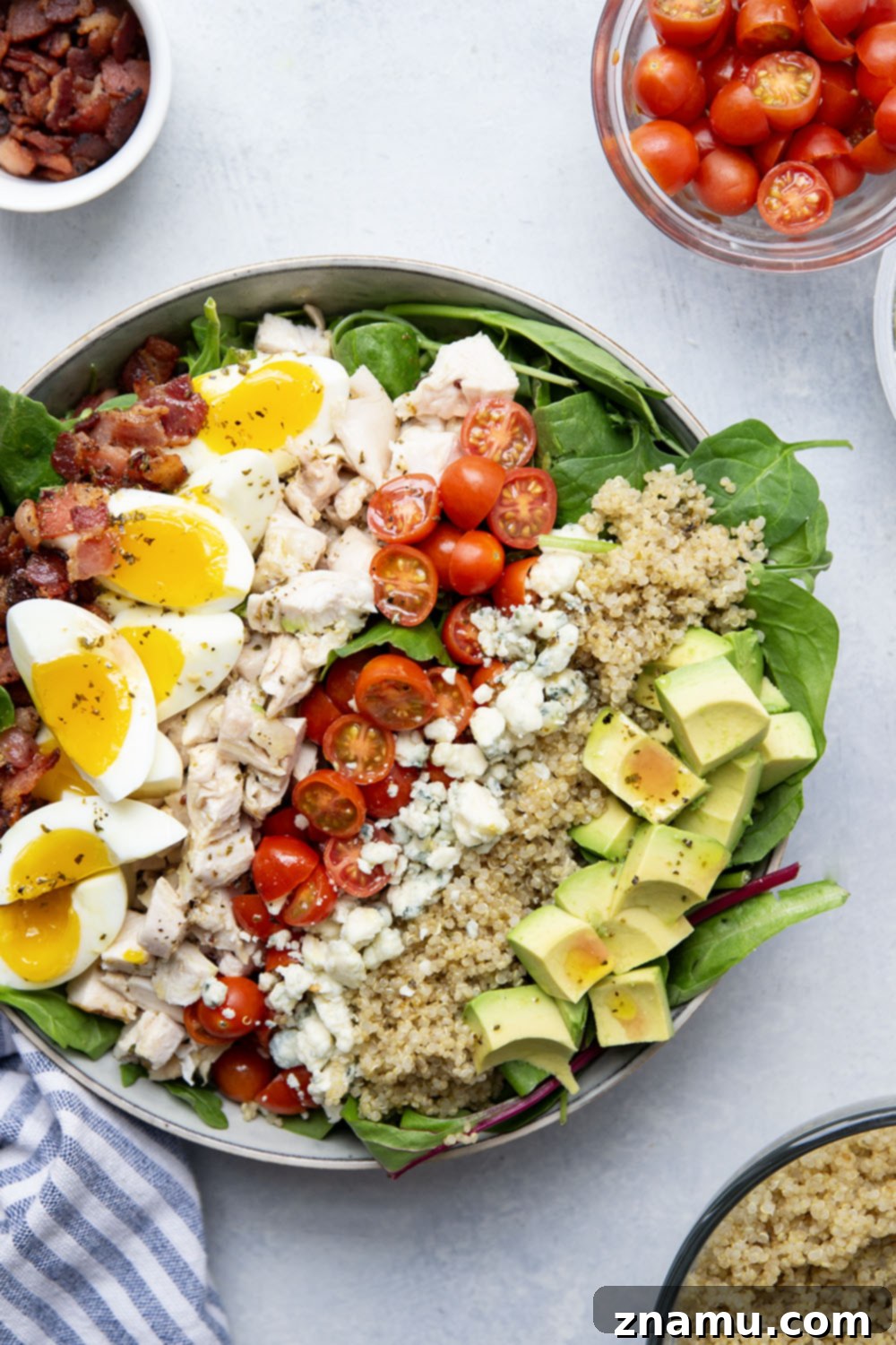 Chicken Quinoa Cobb Creation 3 Close-up of the Chicken Quinoa Cobb Salad showcasing the neat rows of ingredients: golden quinoa, tender chicken, creamy avocado, and bright cherry tomatoes.
