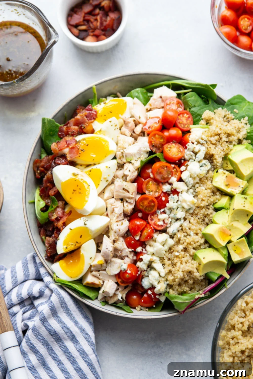 Chicken Quinoa Cobb Creation 6 A vibrant and colorful Chicken Quinoa Cobb Salad artfully arranged in a large serving bowl, ready for enjoyment.