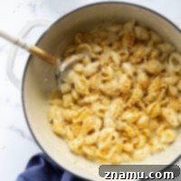 Ultimate White Cheddar Mac and Cheese 8 Perfectly gooey and cheesy, this white cheddar mac and cheese comes together in minutes and is amazing with garlicky toasted breadcrumbs on top!