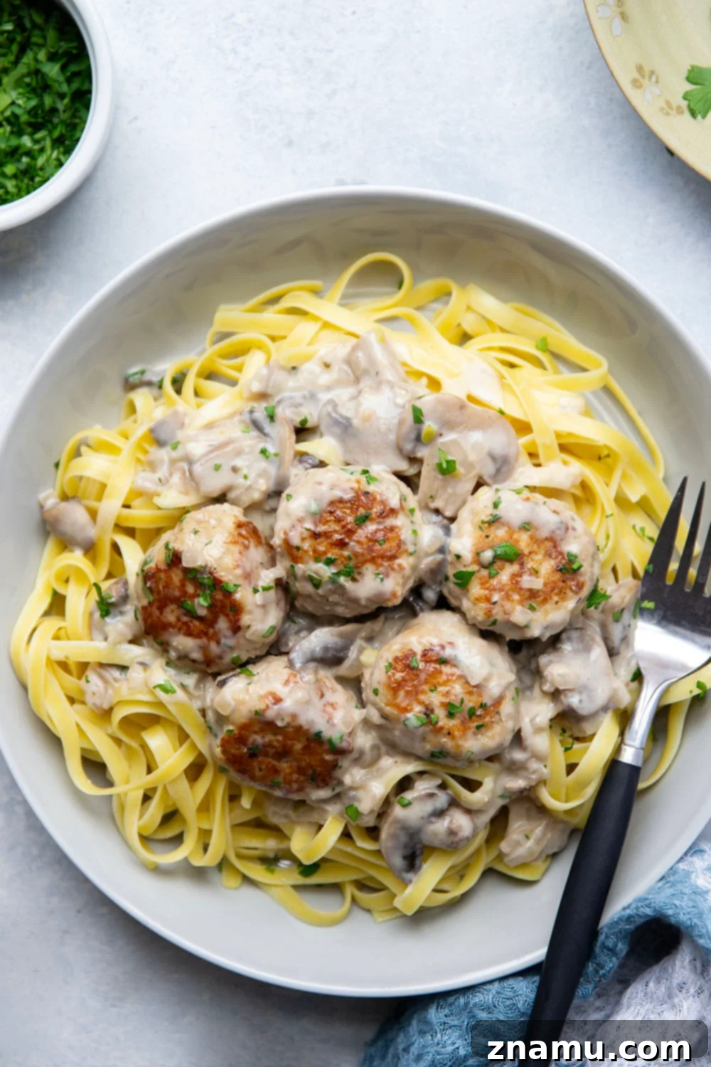 Flavorful Chicken Marsala Meatballs 3 Overhead shot of a skillet filled with chicken marsala meatballs and mushroom sauce.