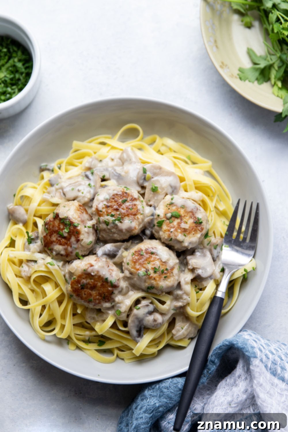 Flavorful Chicken Marsala Meatballs 5 Sautéed sliced mushrooms in a pan, ready for sauce preparation.