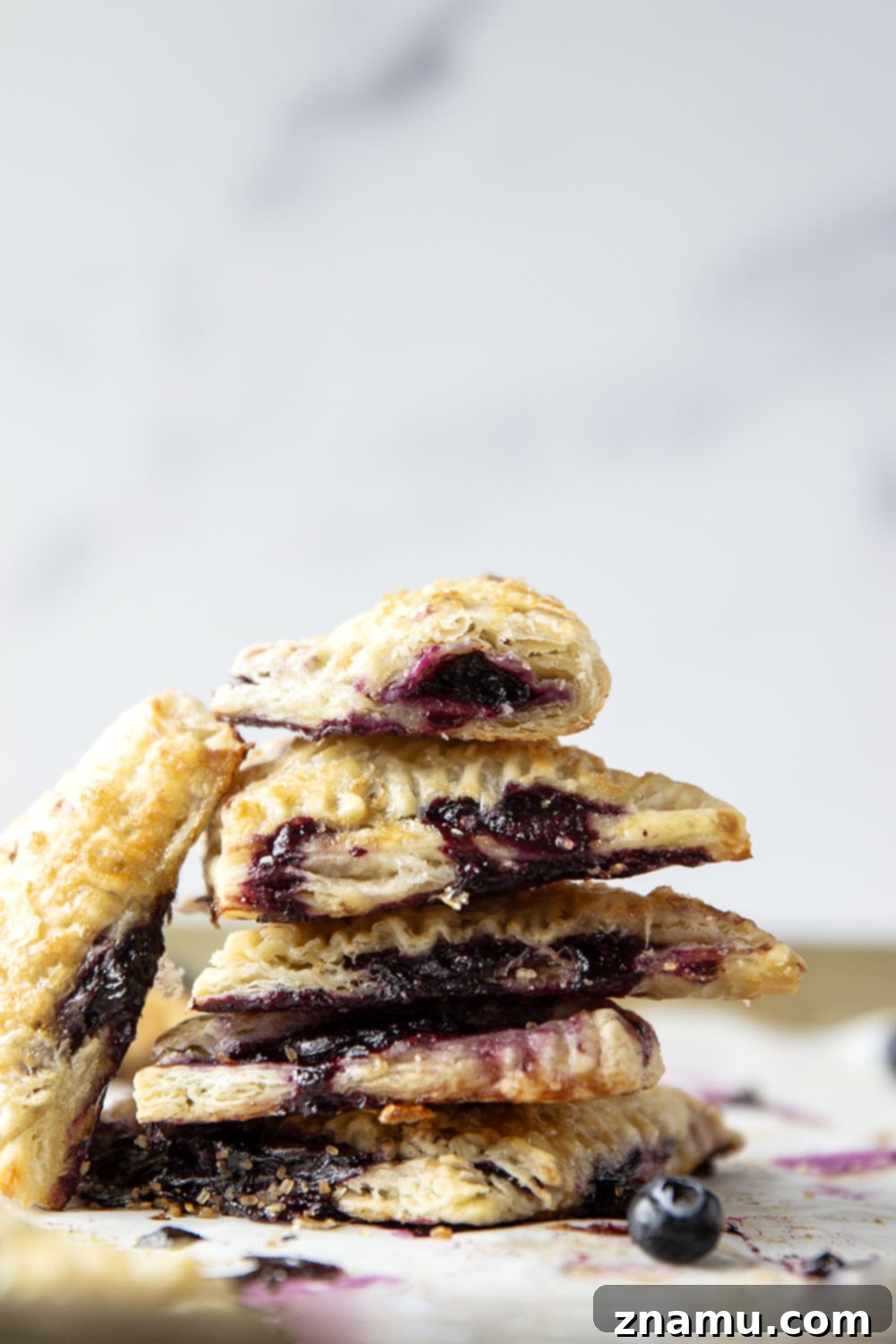Flaky Blueberry Delights 2 These blueberry turnovers feature a juicy blueberry filling stuffed inside the flakiest homemade pastry dough. The perfect mini-sized pastry!