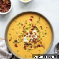 Ultimate Baked Sweet Potato Soup 8 A close-up of the delicious Loaded Baked Sweet Potato Soup, showcasing its creamy texture and rich toppings.