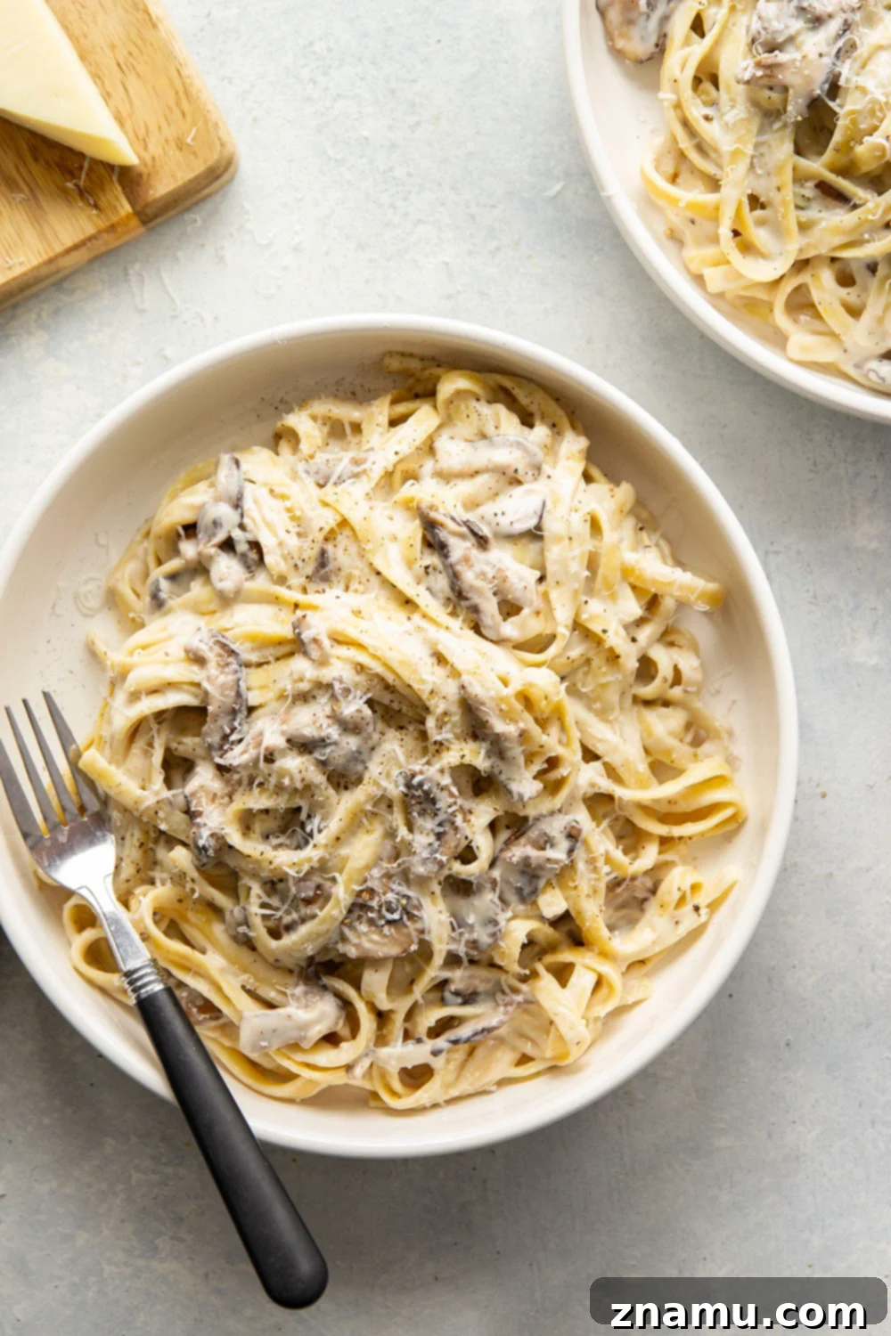 Velvety Asiago Shiitake Alfredo Fettuccine 4 Fresh shiitake mushrooms and grated Asiago cheese, key ingredients for a delicious Alfredo sauce.