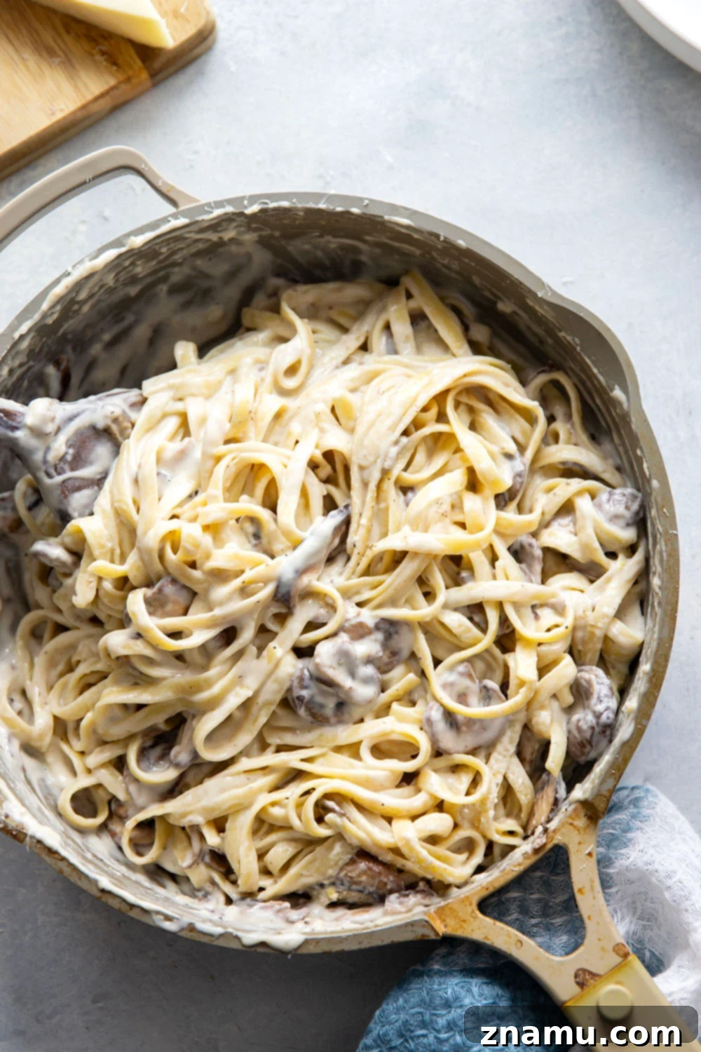Velvety Asiago Shiitake Alfredo Fettuccine 5 A close-up of the rich and creamy Asiago Alfredo sauce, ready to be combined with pasta.