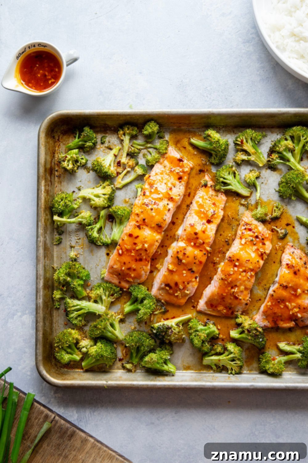 Spicy Honey Glazed Salmon with Roasted Broccoli 3 Close-up shot of perfectly cooked Hot Honey Glazed Salmon fillets with vibrant roasted broccoli, showcasing the delicious sweet and spicy glaze and a healthy, complete meal on one pan.
