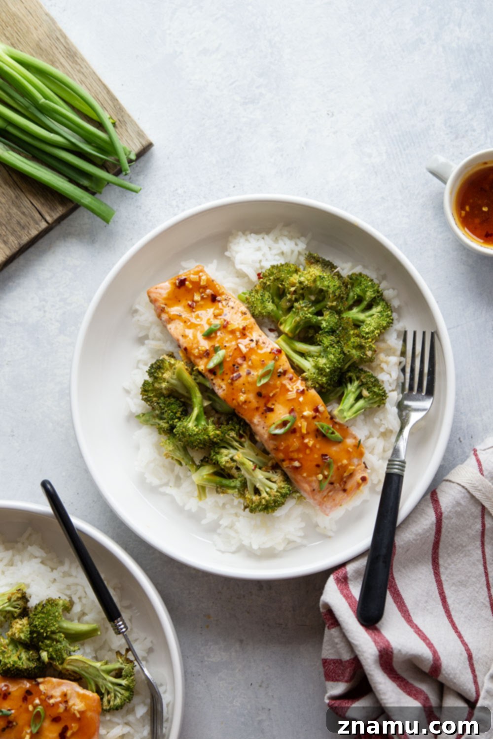 Spicy Honey Glazed Salmon with Roasted Broccoli 5 A sheet pan with hot honey glazed salmon and roasted broccoli, fresh out of the oven, ready to be served. The salmon is perfectly flaky and the broccoli is tender-crisp, all coated in a vibrant, savory glaze.