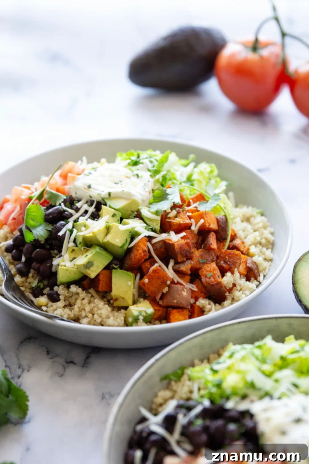 Blackened Sweet Potato & Quinoa Power Bowls 2 These quinoa burrito bowls are piled high with flavorful blackened sweet potato cubes and all the burrito bowl fixins' including black beans, corn, avocado, tomato, and lots of cheese.