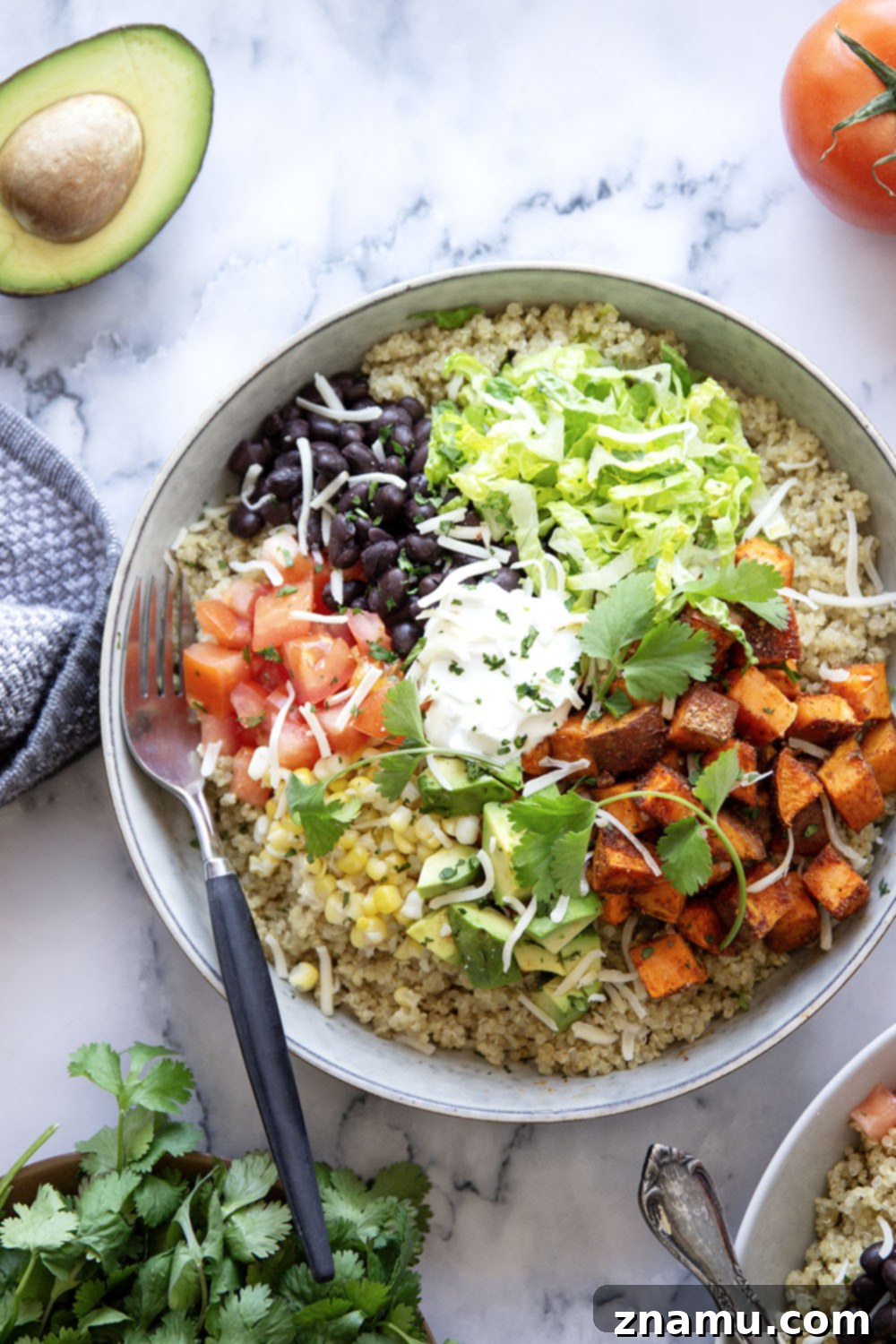 Blackened Sweet Potato & Quinoa Power Bowls 3 These quinoa burrito bowls are piled high with flavorful blackened sweet potato cubes and all the burrito bowl fixins' including black beans, corn, avocado, tomato, and lots of cheese.