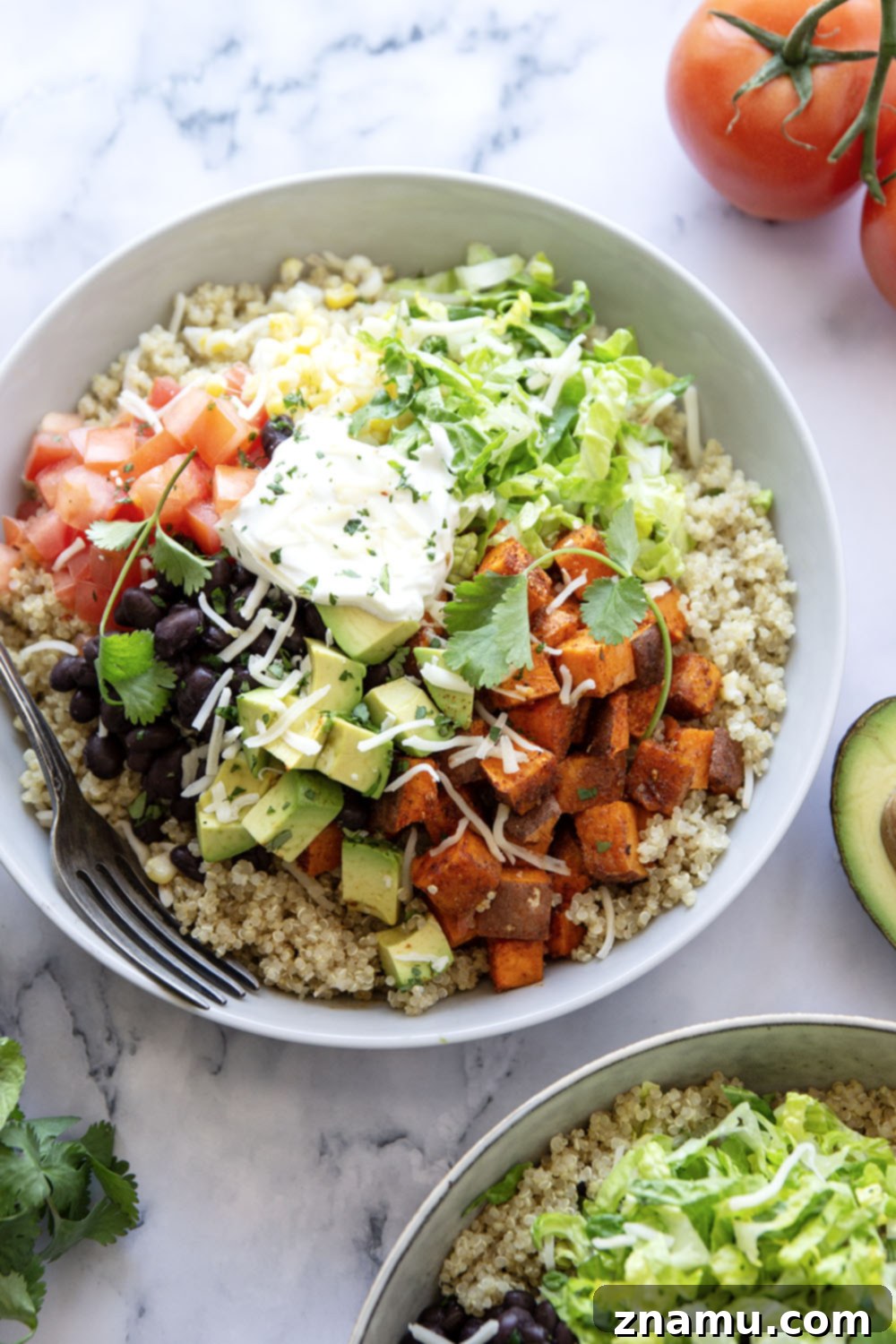 Blackened Sweet Potato & Quinoa Power Bowls 4 These quinoa burrito bowls are piled high with flavorful blackened sweet potato cubes and all the burrito bowl fixins' including black beans, corn, avocado, tomato, and lots of cheese.
