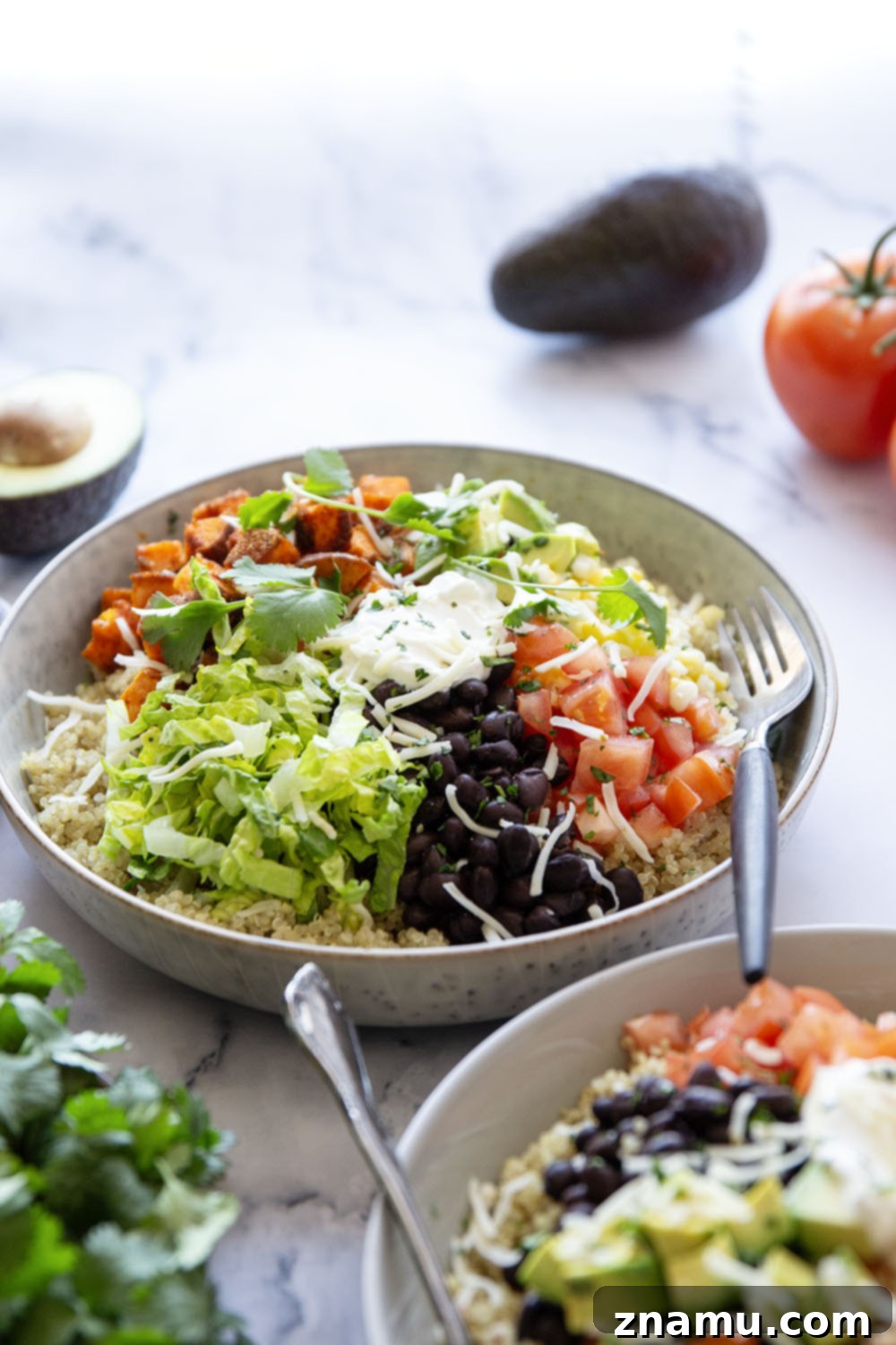 Blackened Sweet Potato & Quinoa Power Bowls 5 These quinoa burrito bowls are piled high with flavorful blackened sweet potato cubes and all the burrito bowl fixins' including black beans, corn, avocado, tomato, and lots of cheese.