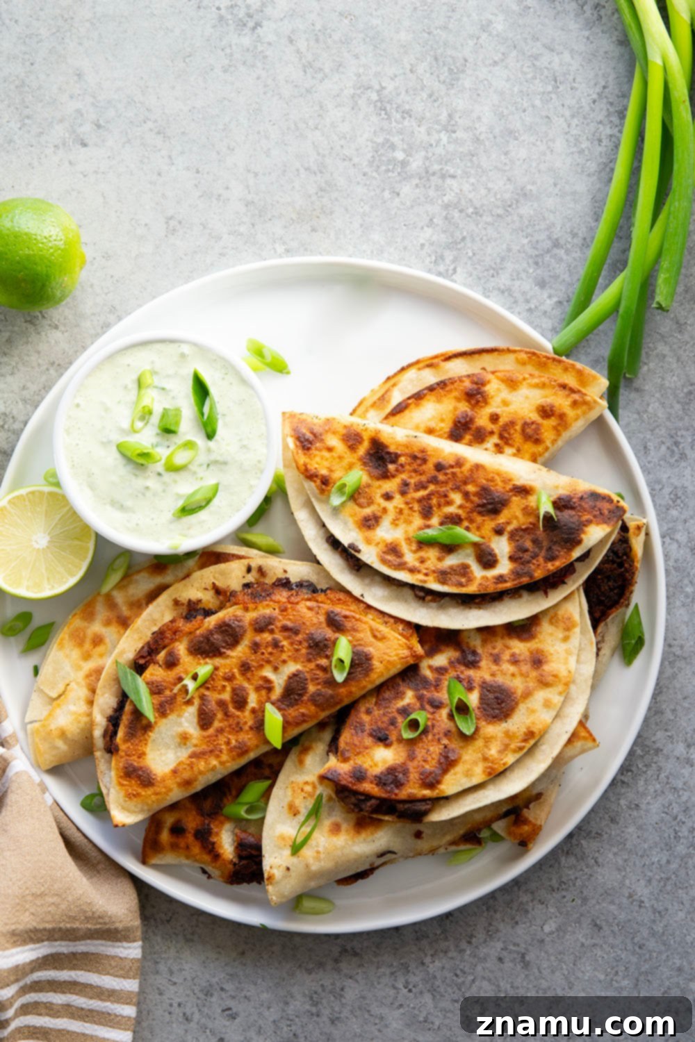 Crispy Black Bean Tacos with Zesty Scallion Lime Sauce 4 Stuffed with a creamy smashed black bean filling and lots of cheese, these crispy black bean tacos are amazing paired with a flavorful scallion lime sauce for dipping.